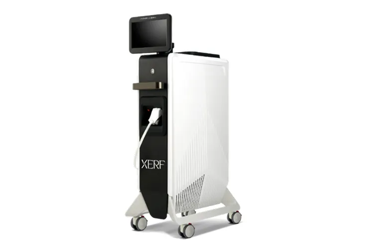 Tall white medical device on a rolling stand with a top touchscreen monitor and visible power plug (brand XERF)